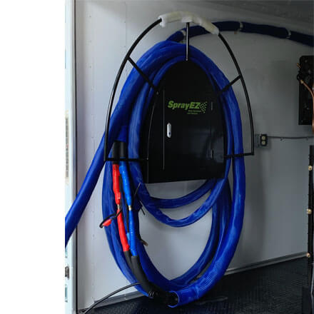 Spray foam hose on holder