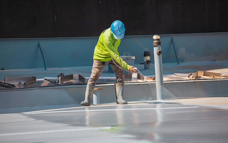 Insulating a commercial roof with Expandothane roofing insulation.