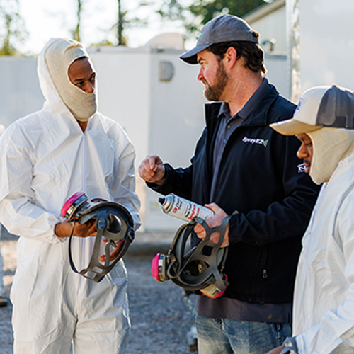 Spray foam professional and crew wearing safety & PPE equipment