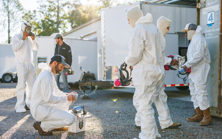employees putting on their safety gear to spray foam